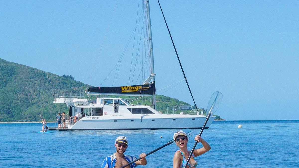 Guest in kayak together with boat in the background