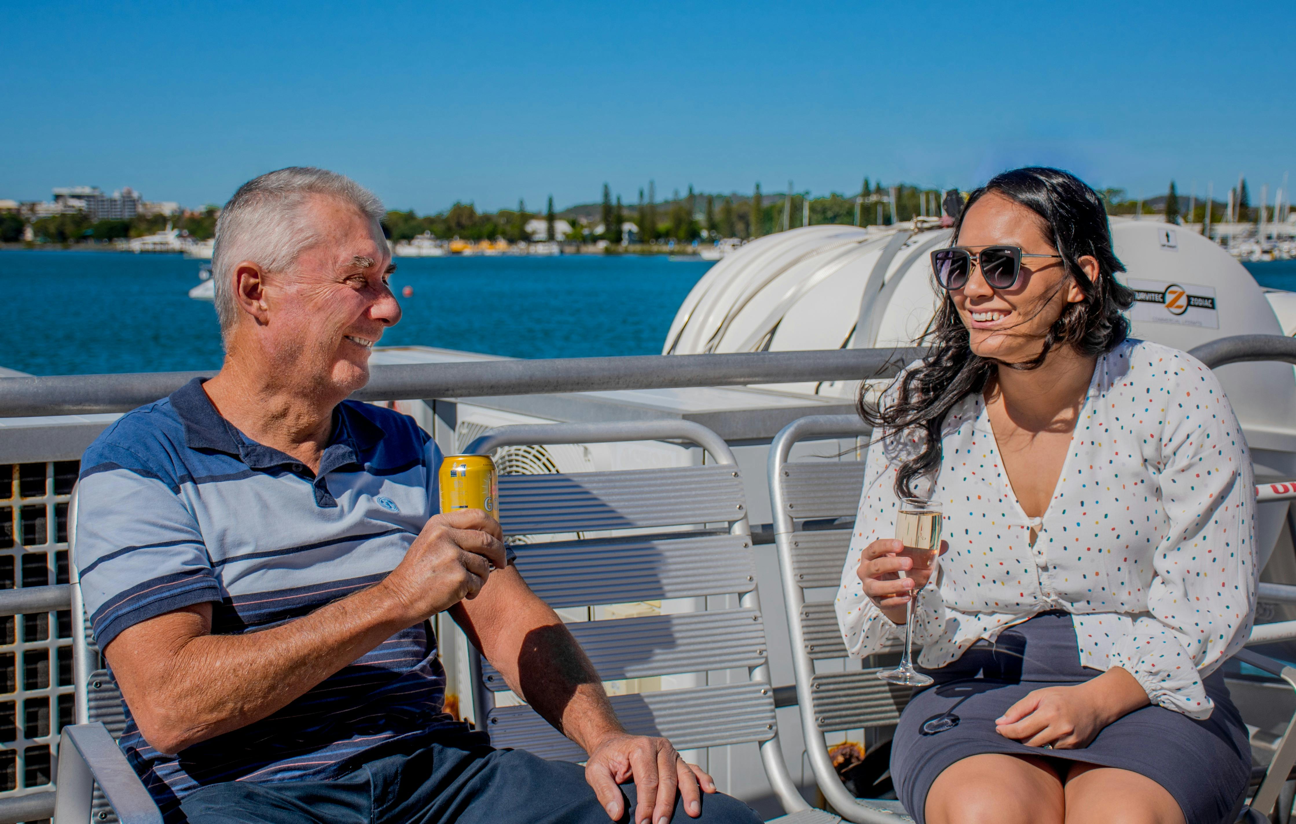 two people enjoying drink onboard outside deck