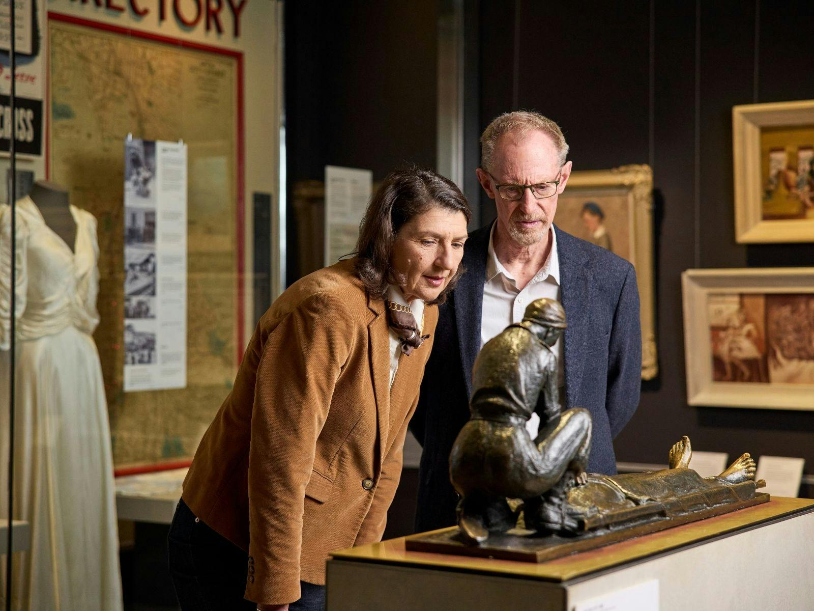 An older couple looking at a statue in the galleries of the Australian War Memorial
