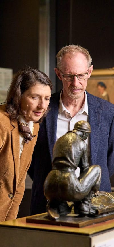 An older couple looking at a statue in the galleries of the Australian War Memorial