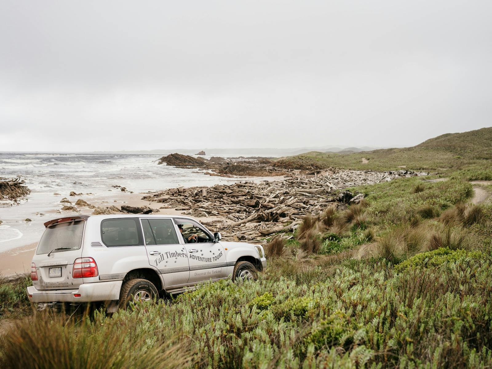 Vehicle on rough terrain and single vehicle width  dual track along the rugged Tarkine coast