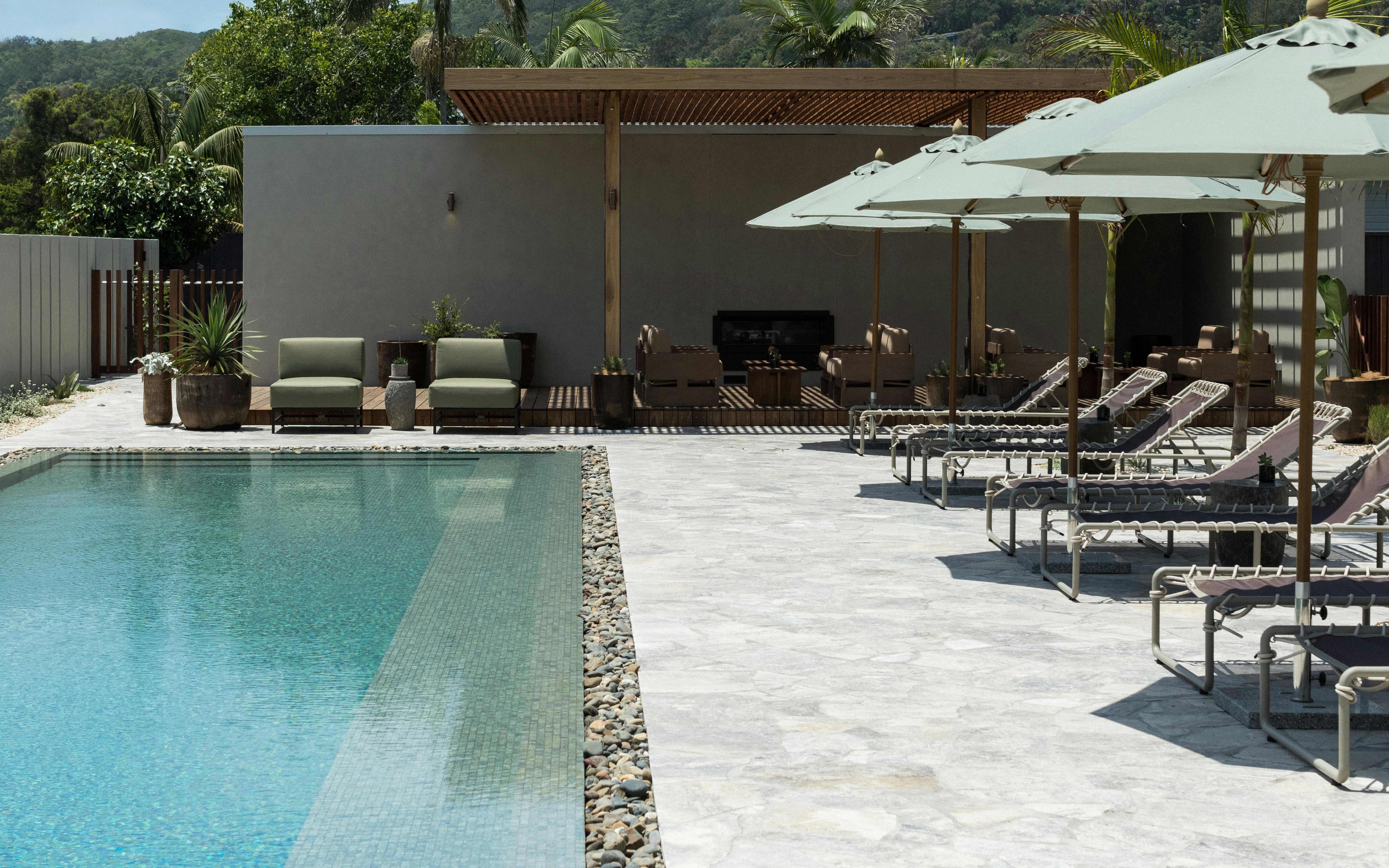 Pool facility for hotel guests. Including outdoor fireplace by outdoor lounges.