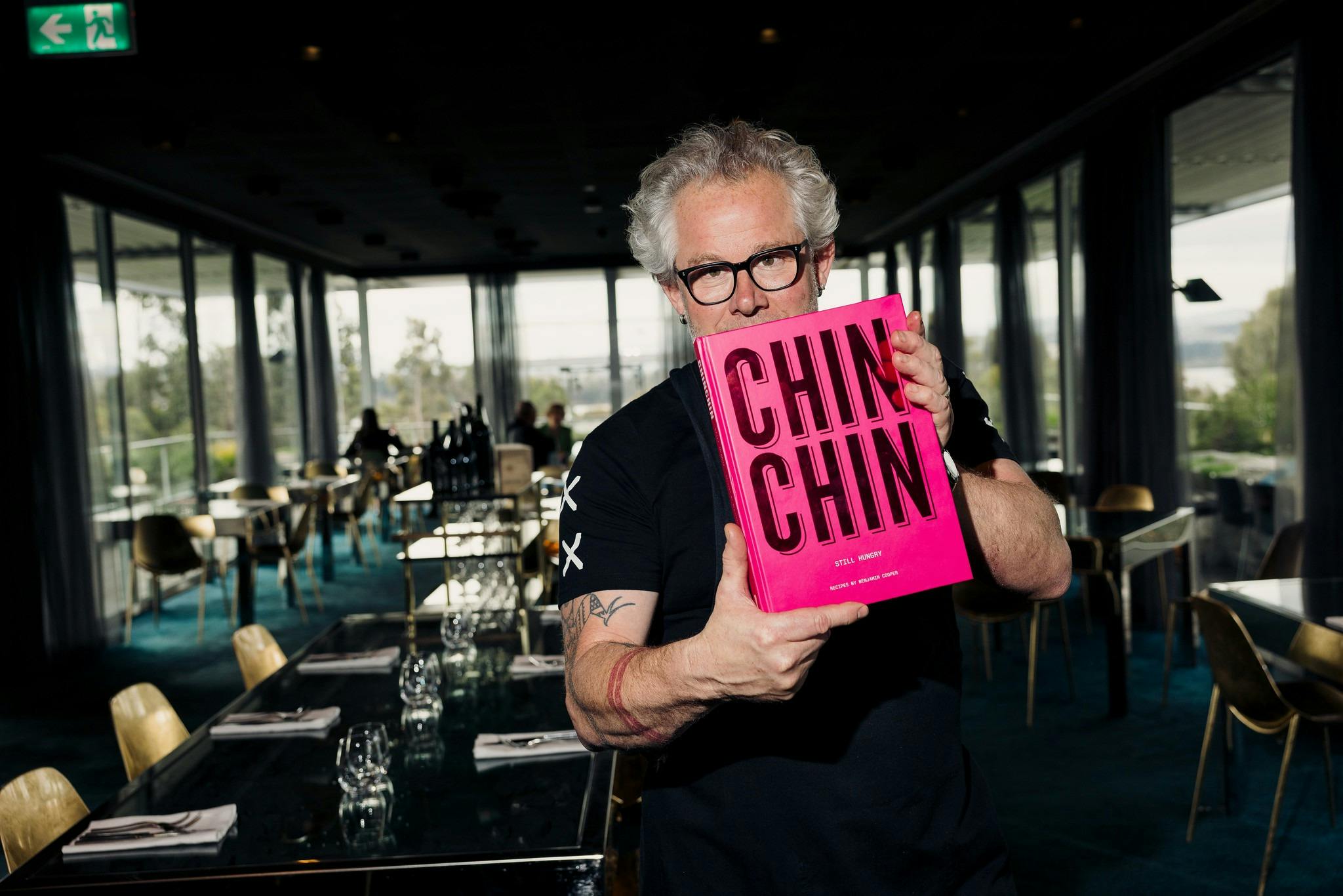 Mona's Chef, Vince Trim, holds a copy of Chin Chin's new cook book