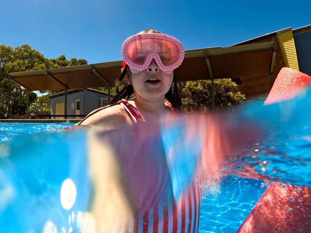Young girl in a snorkel mask enjoying the pool at South Shores.