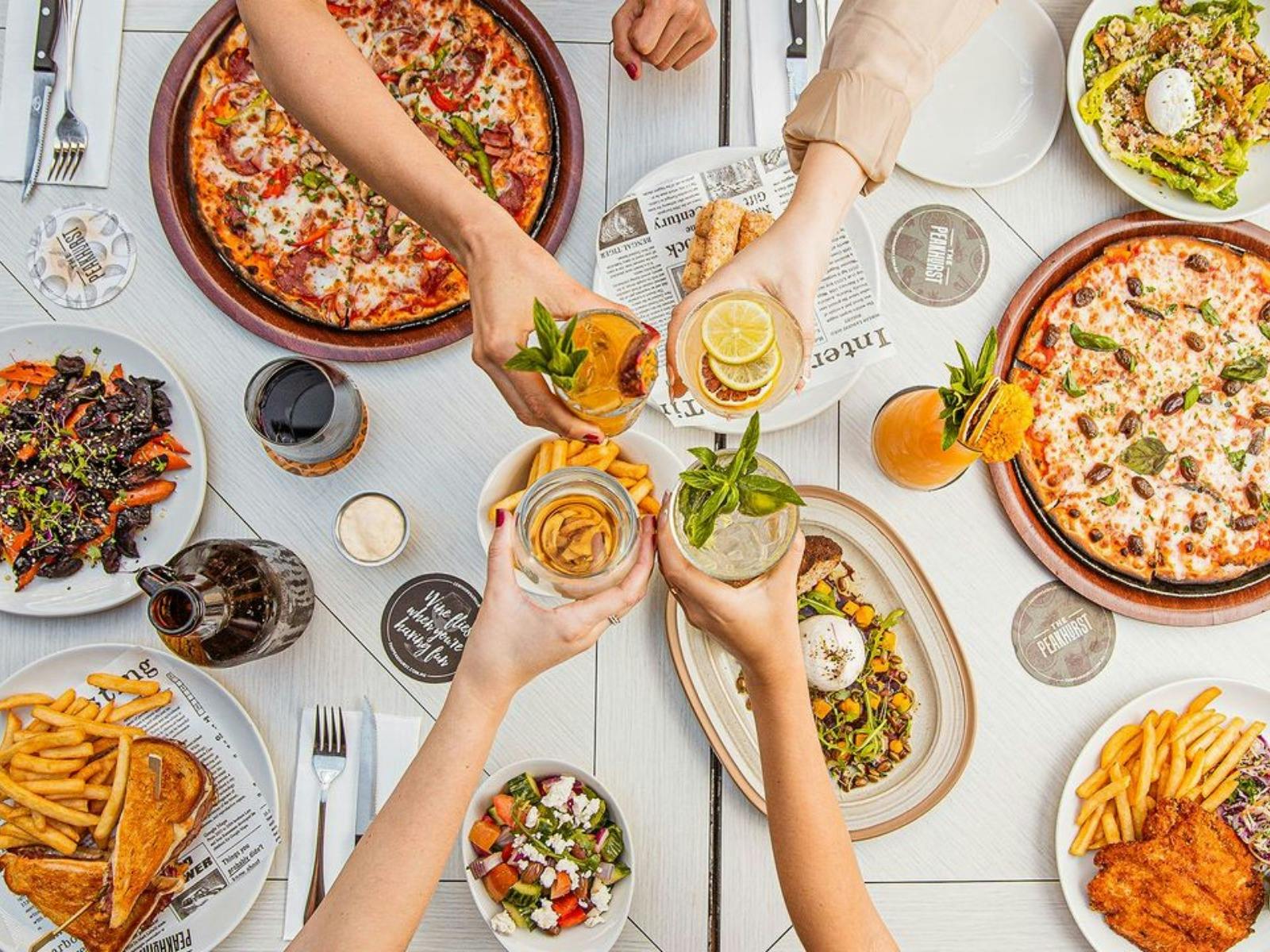 Overhead shot of people sharing meals and drinks