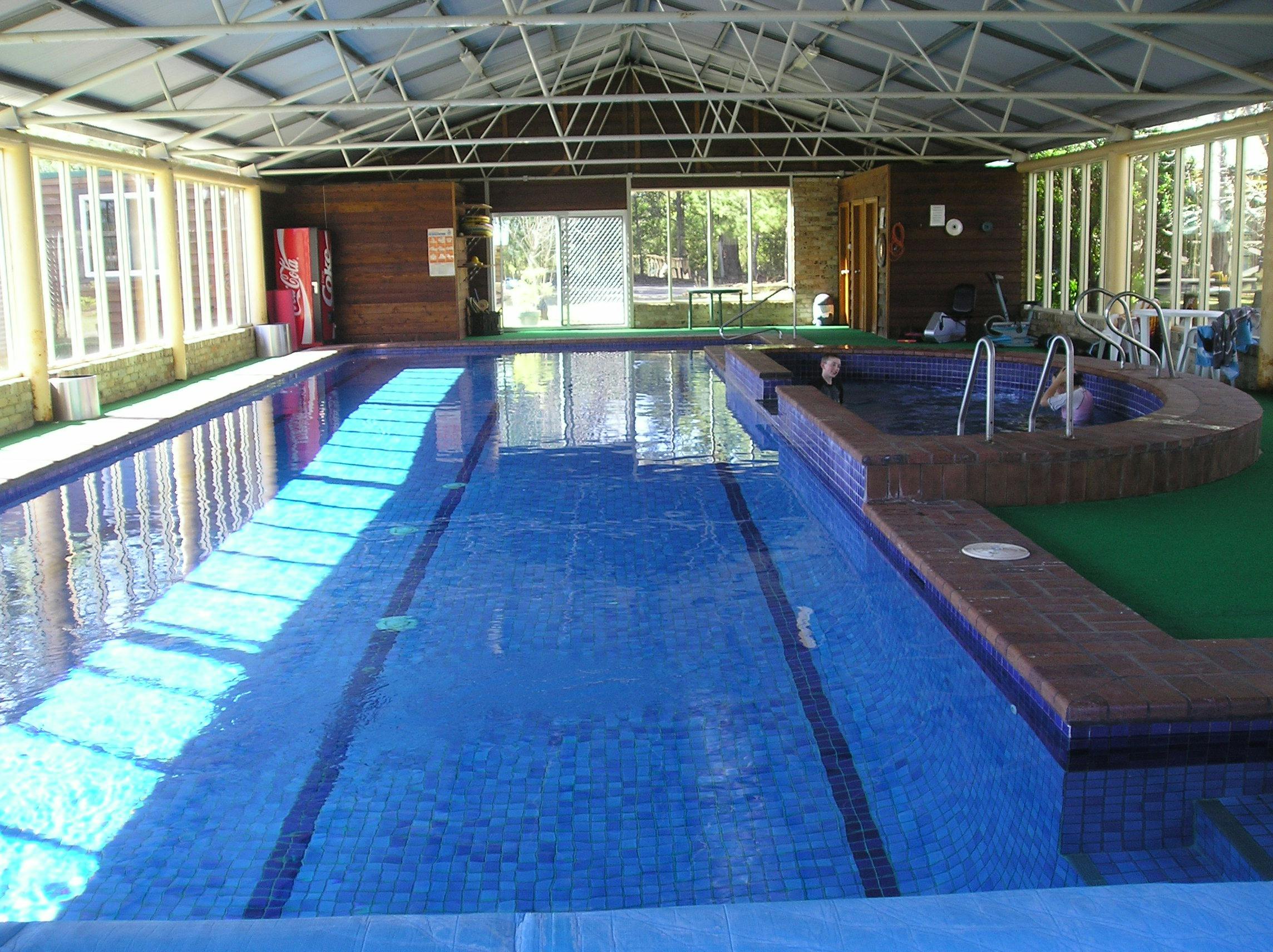 Sunshining on an indoor pool and spa through big glass windows