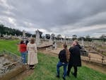 Guide leading a group of visitors on a walking tour through Wagga Wagga’s Old Monumental Cemetery, e