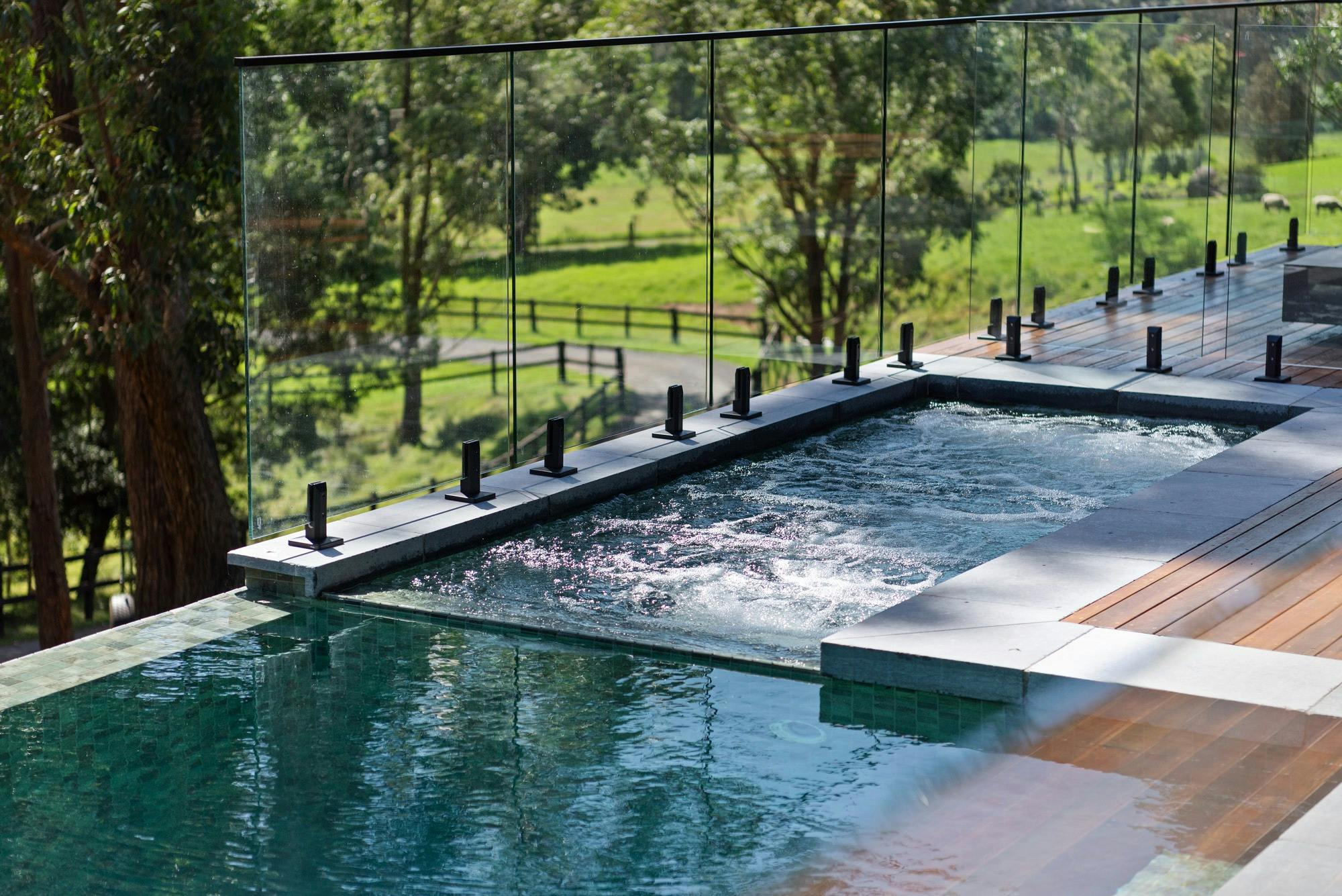 Heated spa with lush landscape views