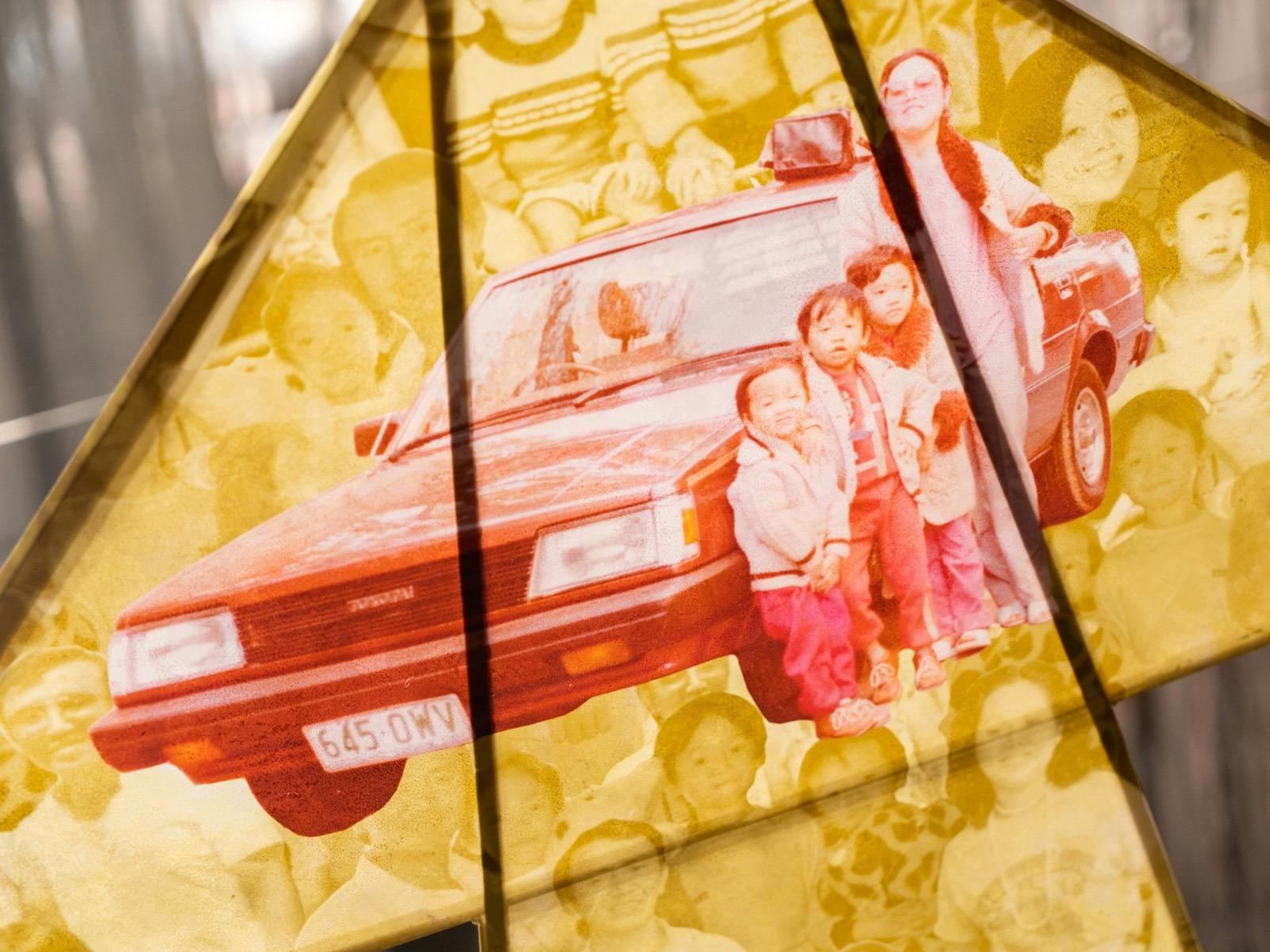 A colourful handmade kite featuring family photographs.