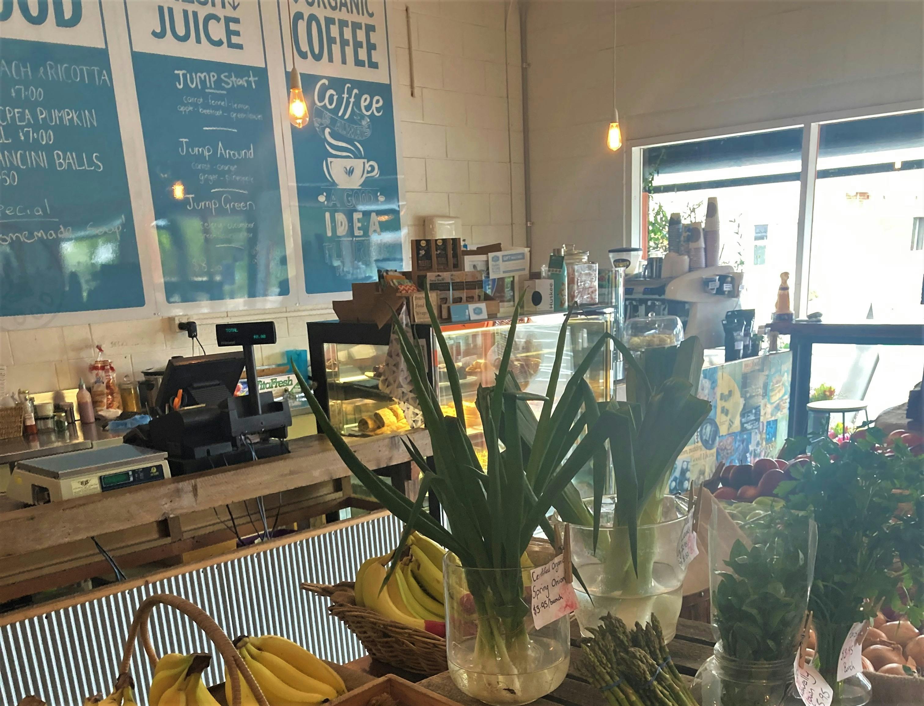 front counter with signs in the background for juice and coffee