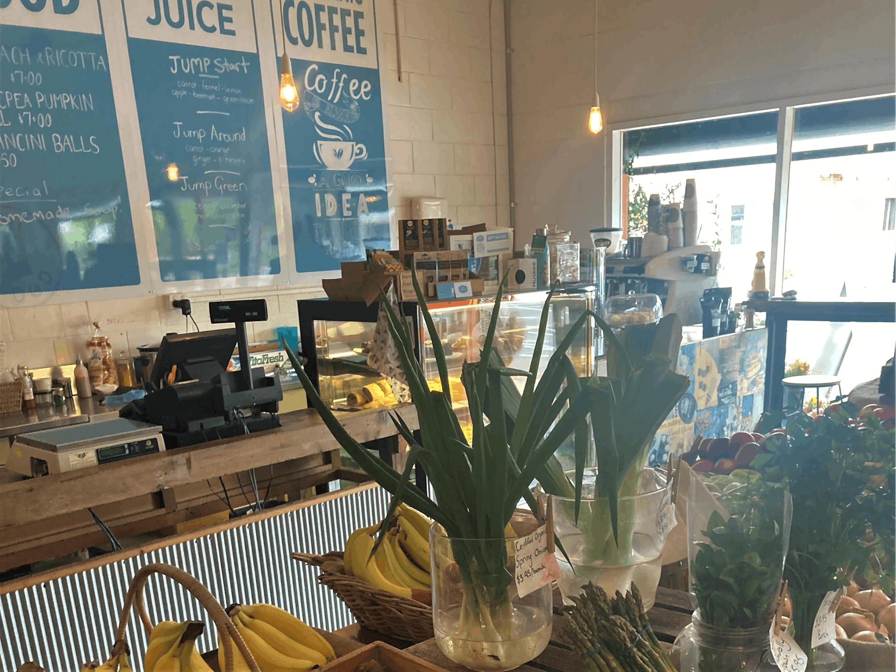 front counter with signs in the background for juice and coffee