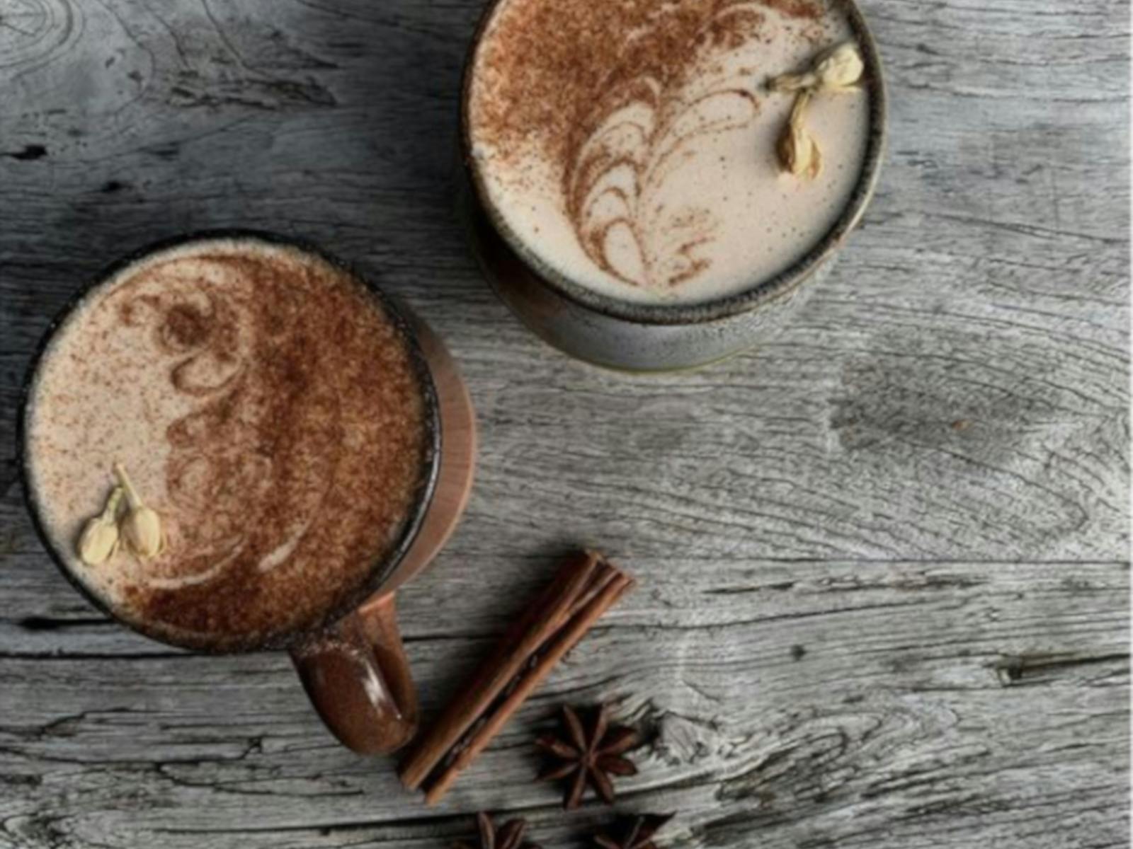 two delicious Chai Lattes on a timber table