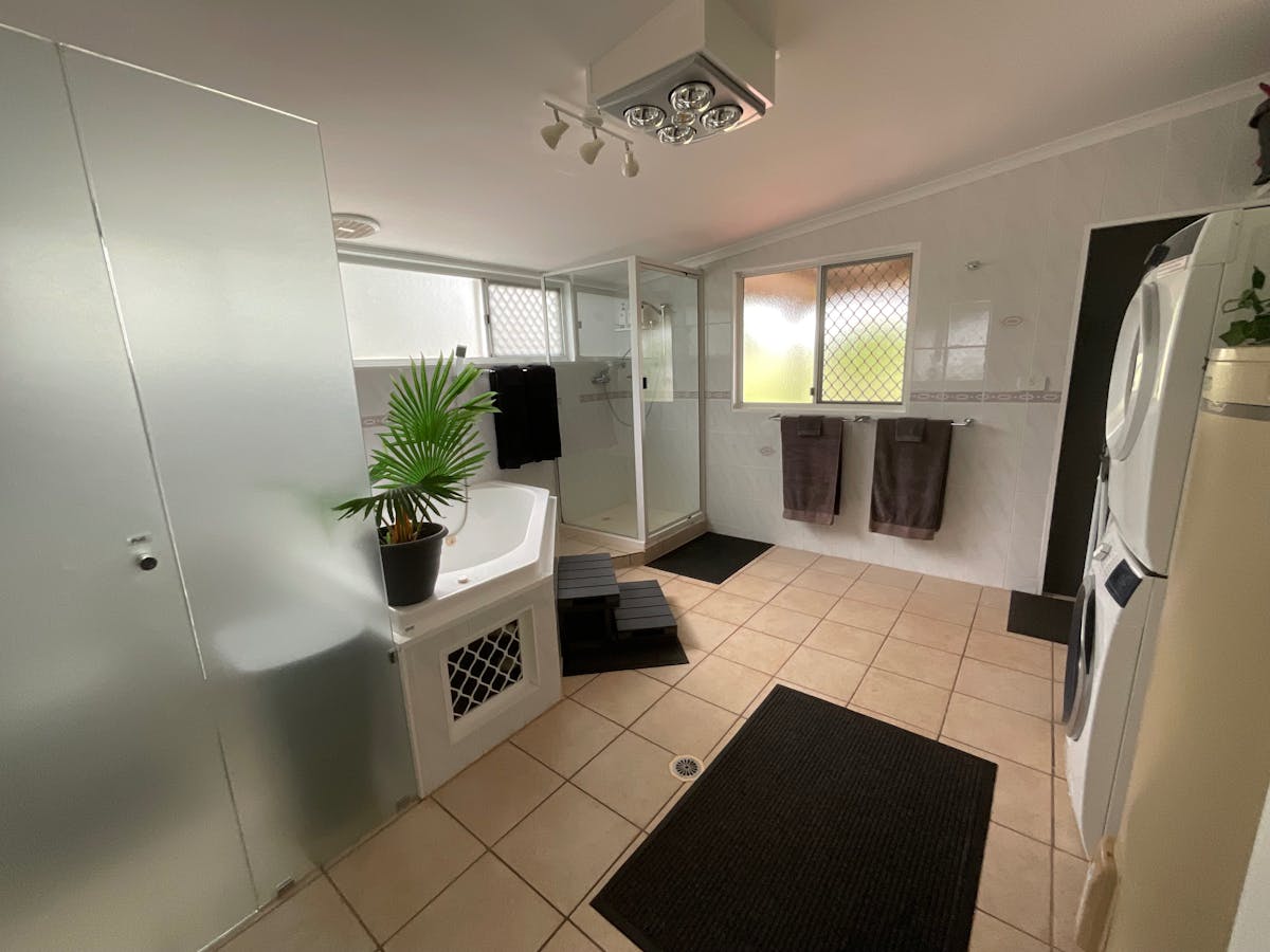 Main bathroom/laundry with separate bath, standalone shower, washing machine and dryer