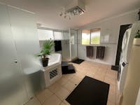 Main bathroom/laundry with separate bath, standalone shower, washing machine and dryer