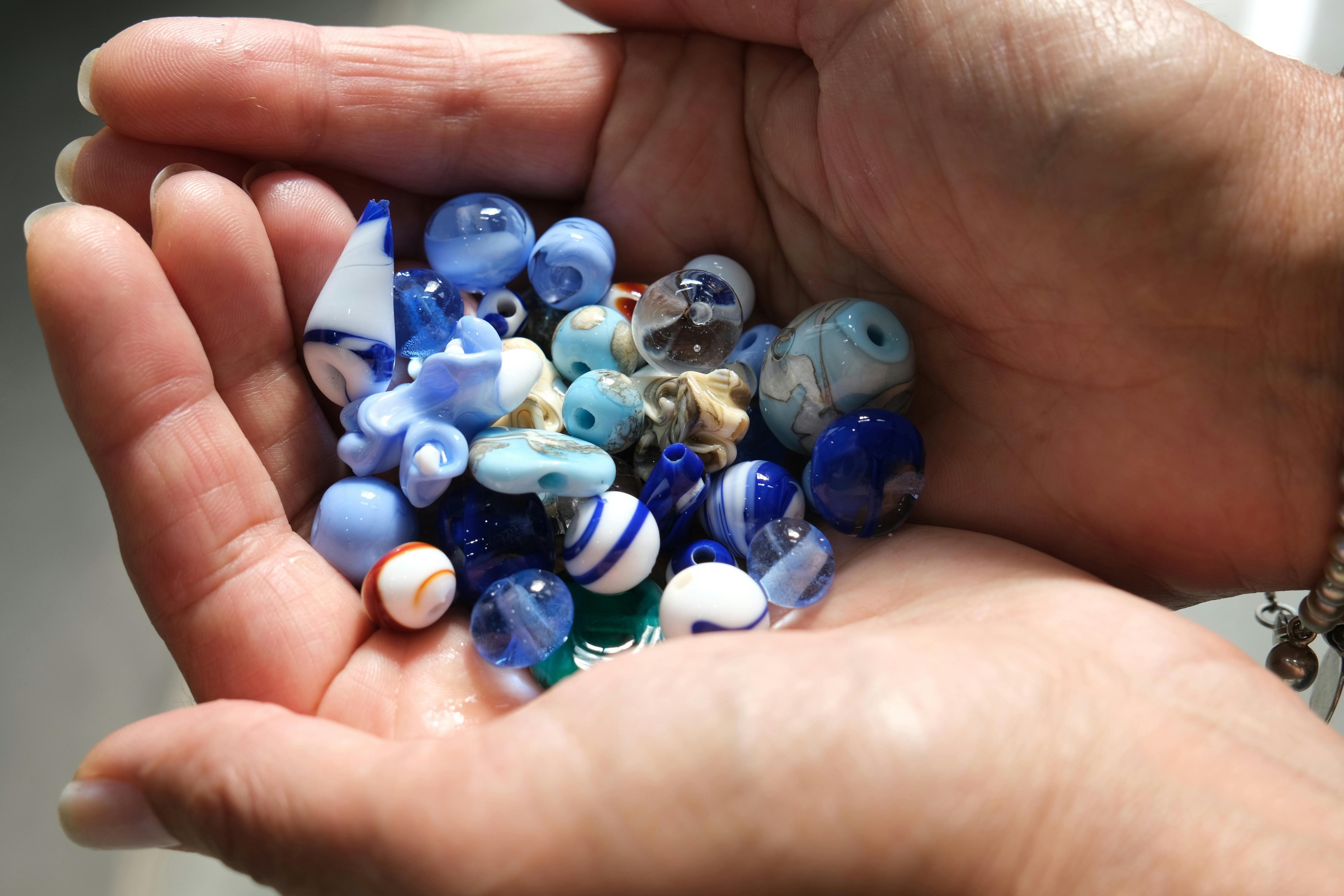 Handmade glass beads in hand