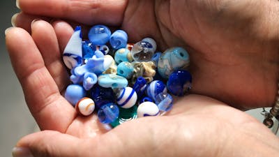 Handmade glass beads in hand
