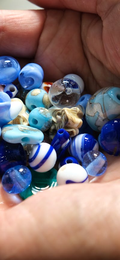 Handmade glass beads in hand