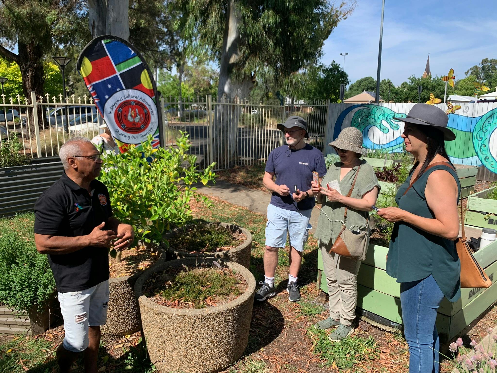 3 guests learning about edible plants