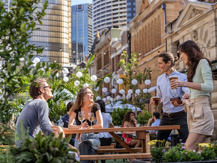Couples enjoying the outdoor dining seating areas in The Rocks, Sydney