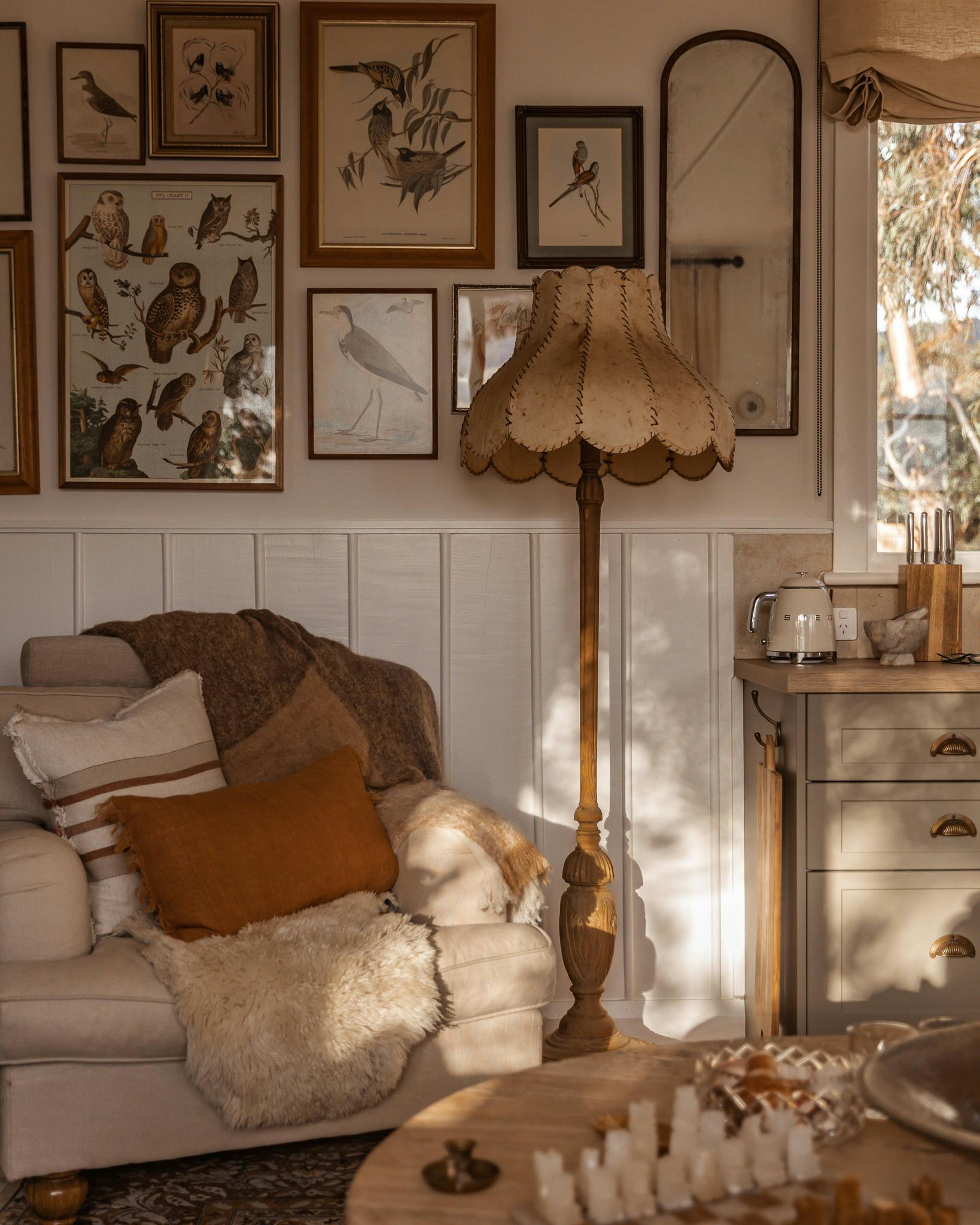 Afternoon light fills this cosy corner, where vintage textures and birdlife prints invite you to pau