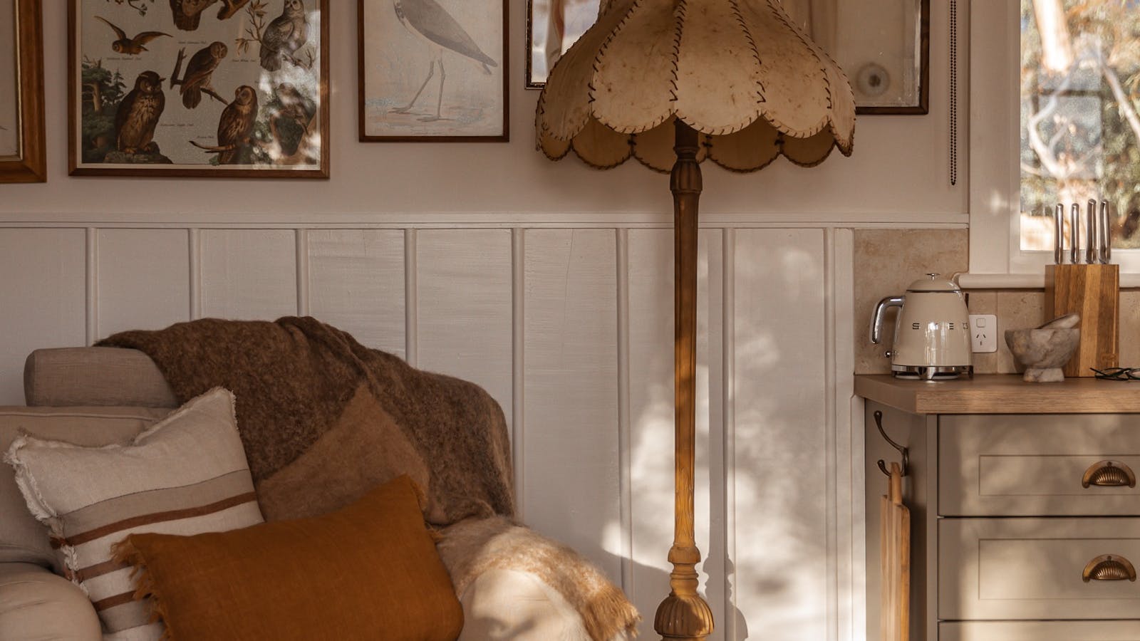 Afternoon light fills this cosy corner, where vintage textures and birdlife prints invite you to pau