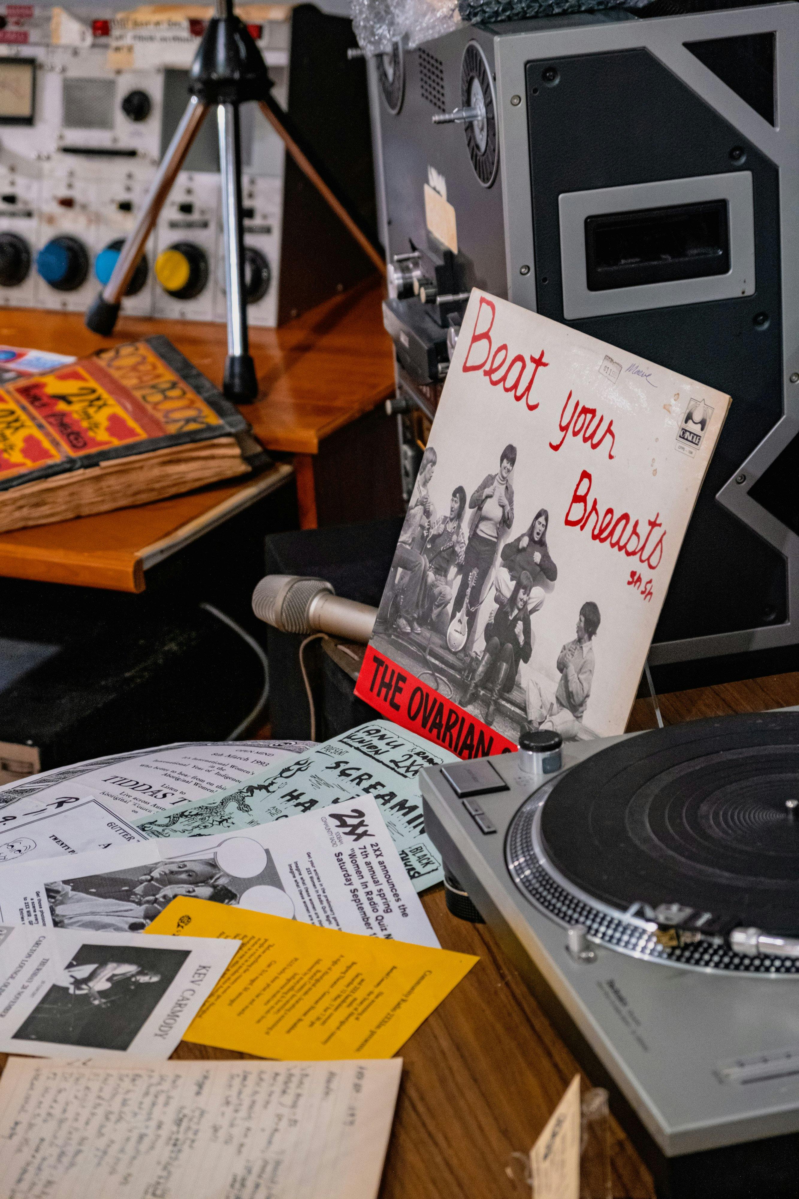 A mock studio desk with record reading 'Beat Your Breasts' in the 2XX exhibition at CMAG