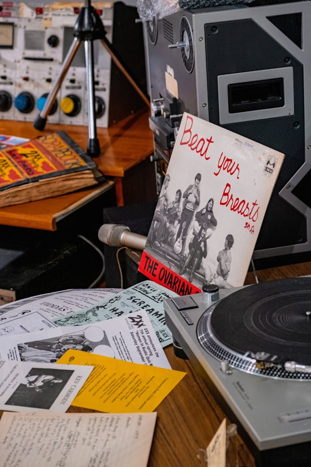 A mock studio desk with record reading 'Beat Your Breasts' in the 2XX exhibition at CMAG