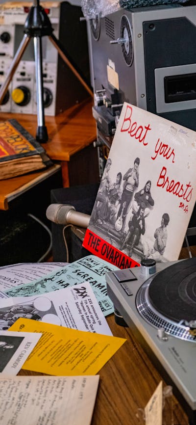 A mock studio desk with record reading 'Beat Your Breasts' in the 2XX exhibition at CMAG