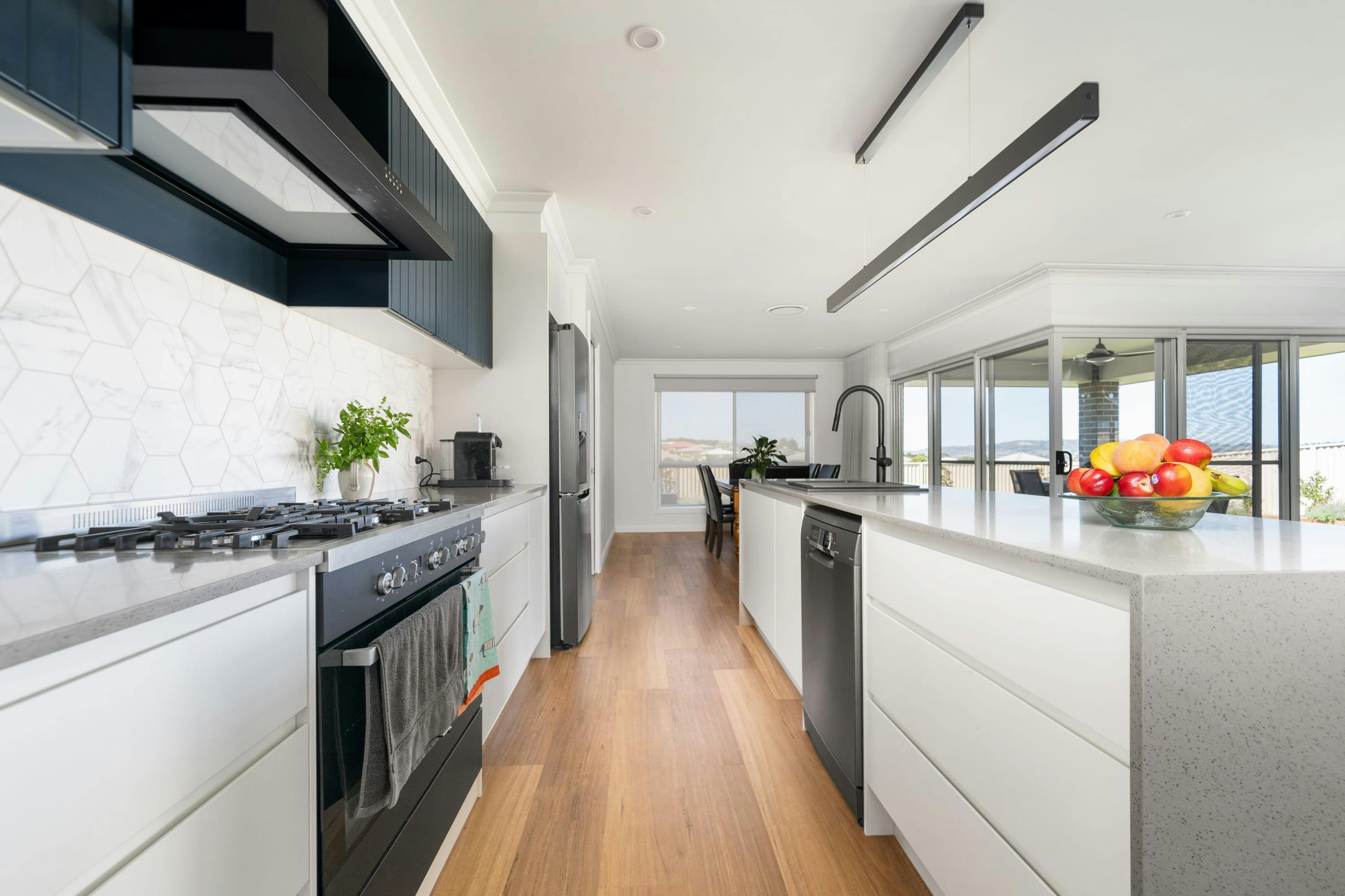 Kitchen with island bench, appliances and amenities