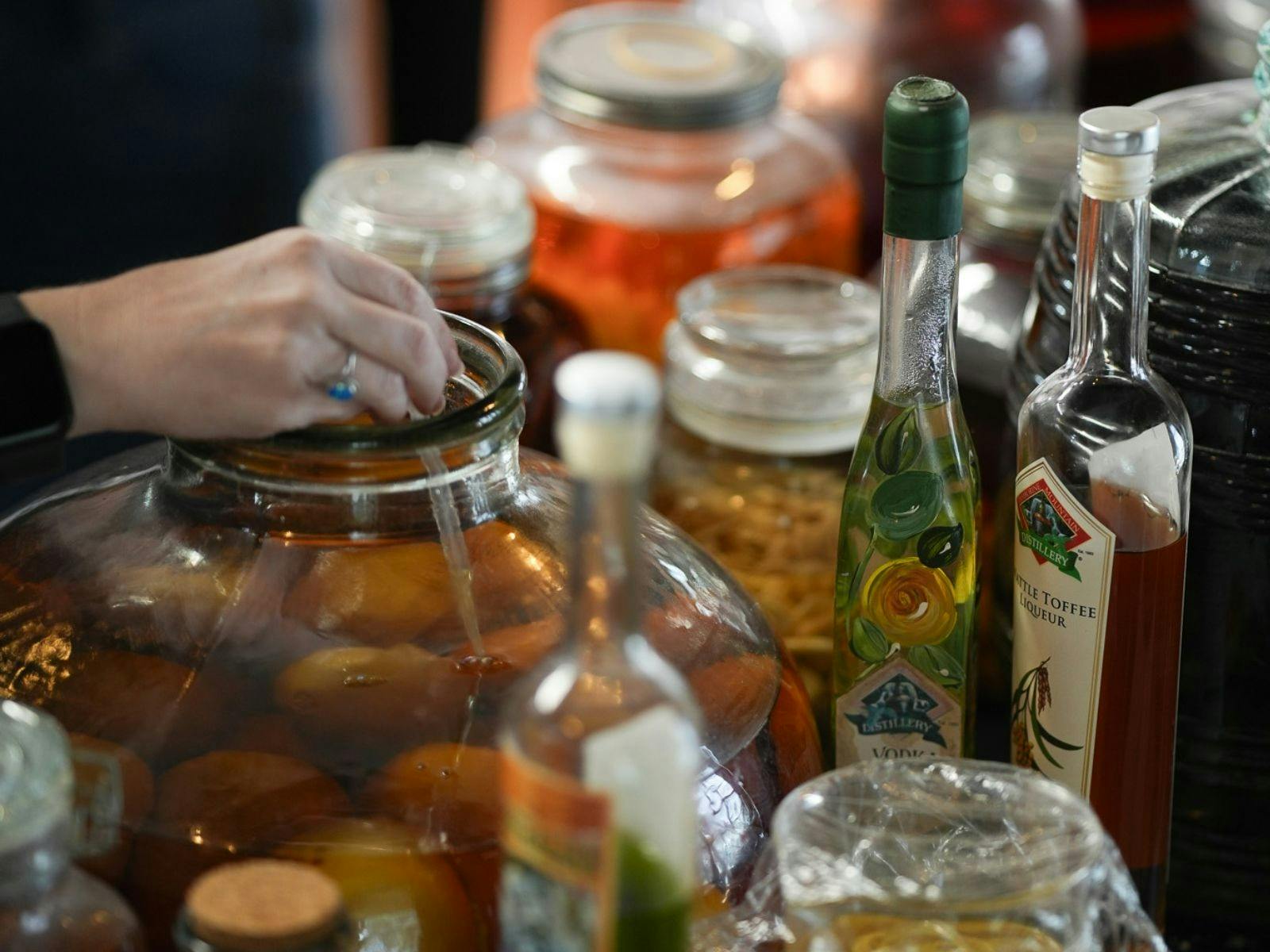 People choosParticipant selecting and adding tinctures during spirit blending class.ing tincture