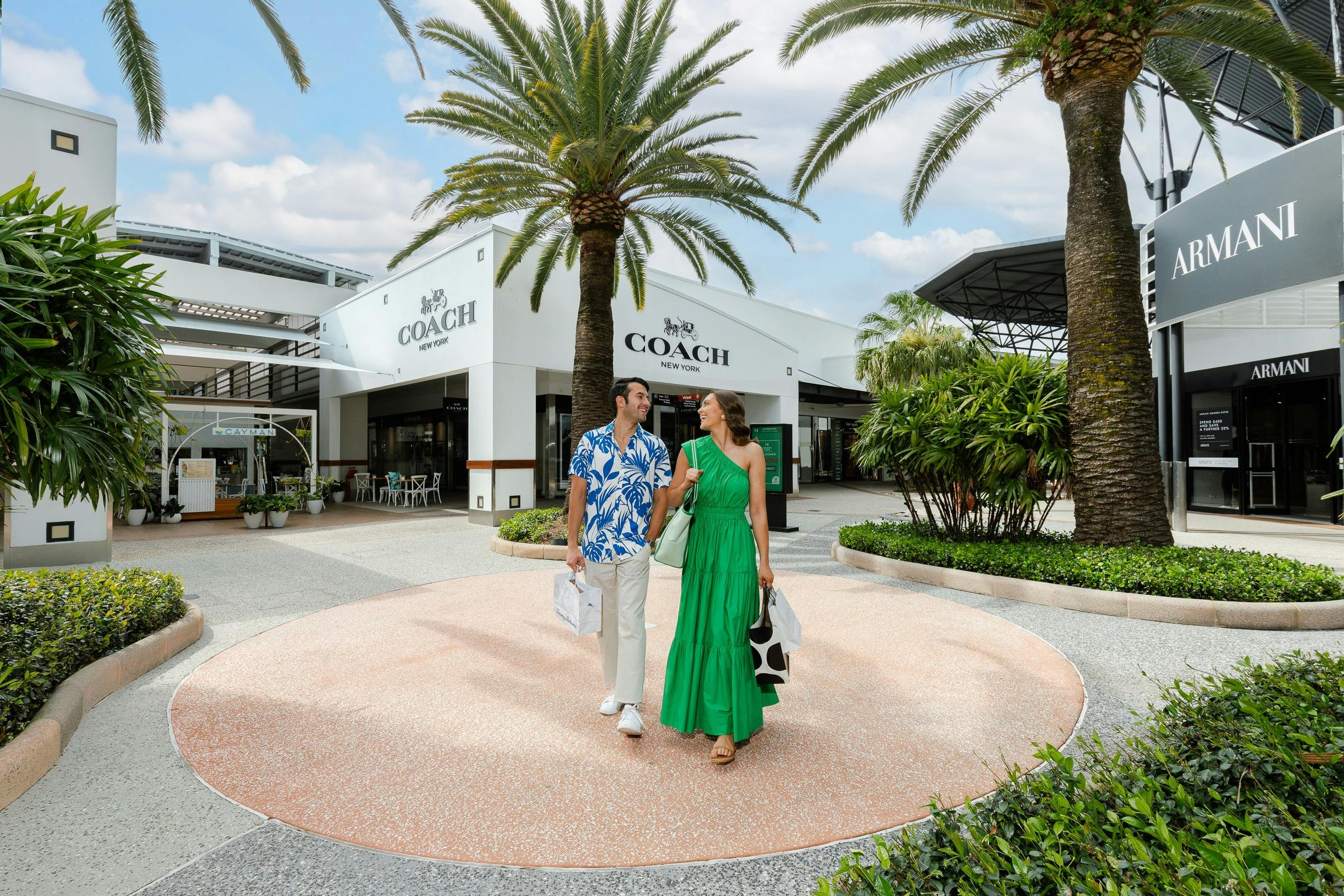 Couple walking through palm tree malls