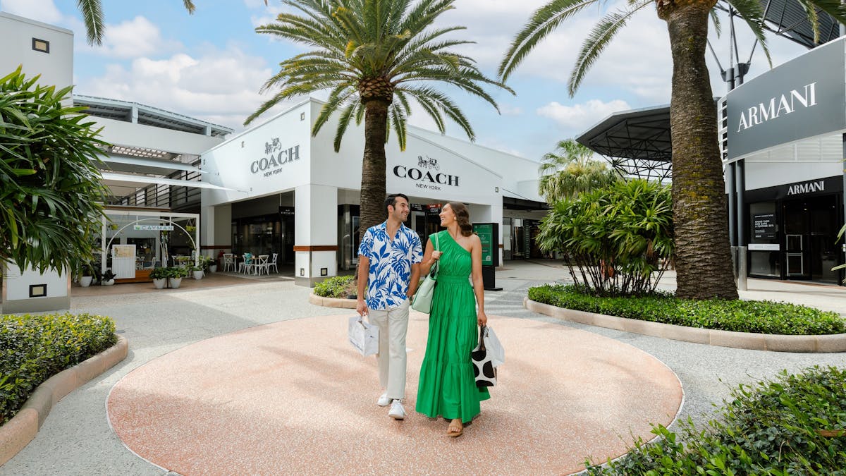Couple walking through palm tree malls