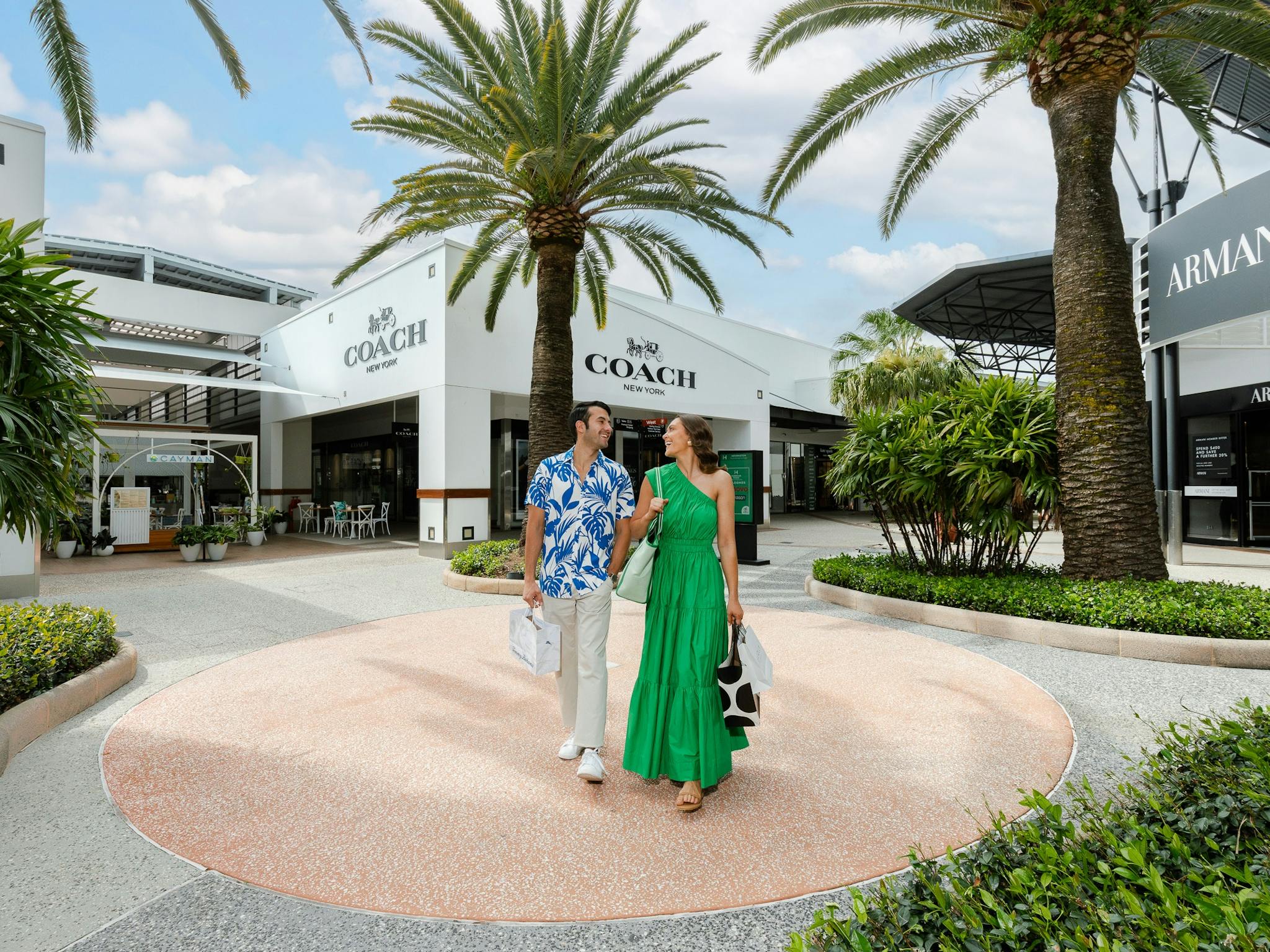Couple walking through palm tree malls