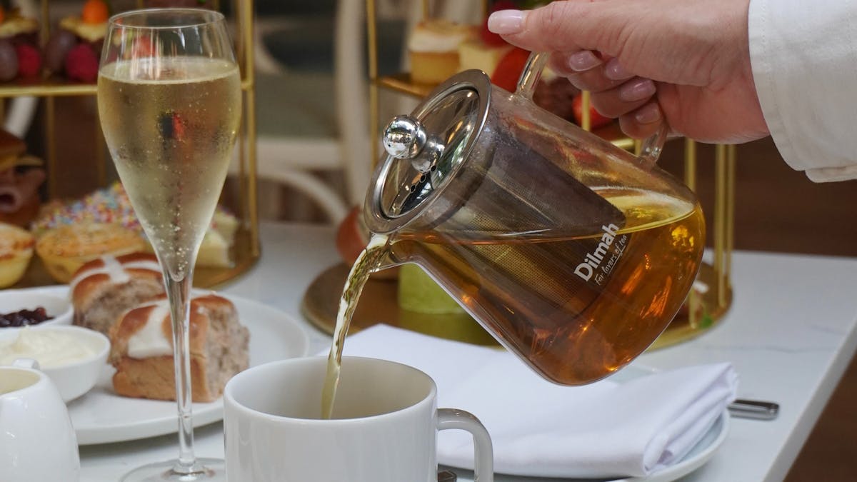 Poring tea into mug