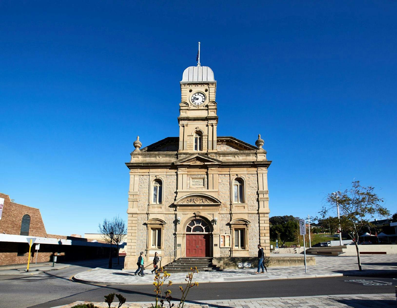 Front of Albany Town Hall stone building with central clock tower