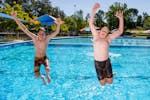 Boys jumping into Lake Talbot Swimming Complex