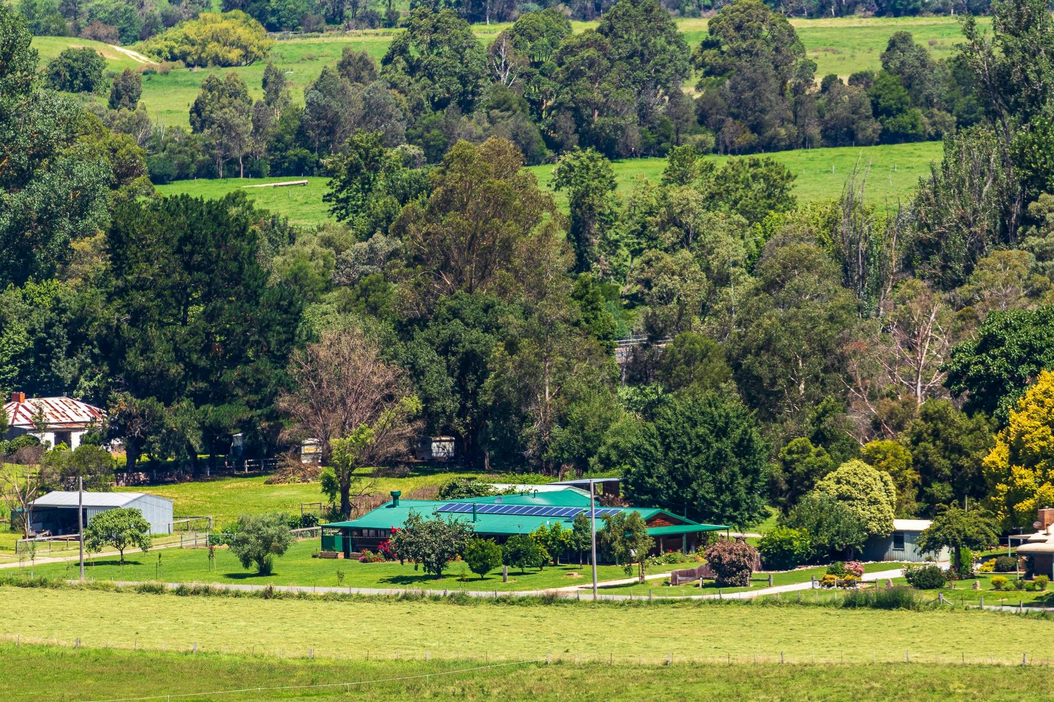 a building Nestled among hills and trees of the bushlands
