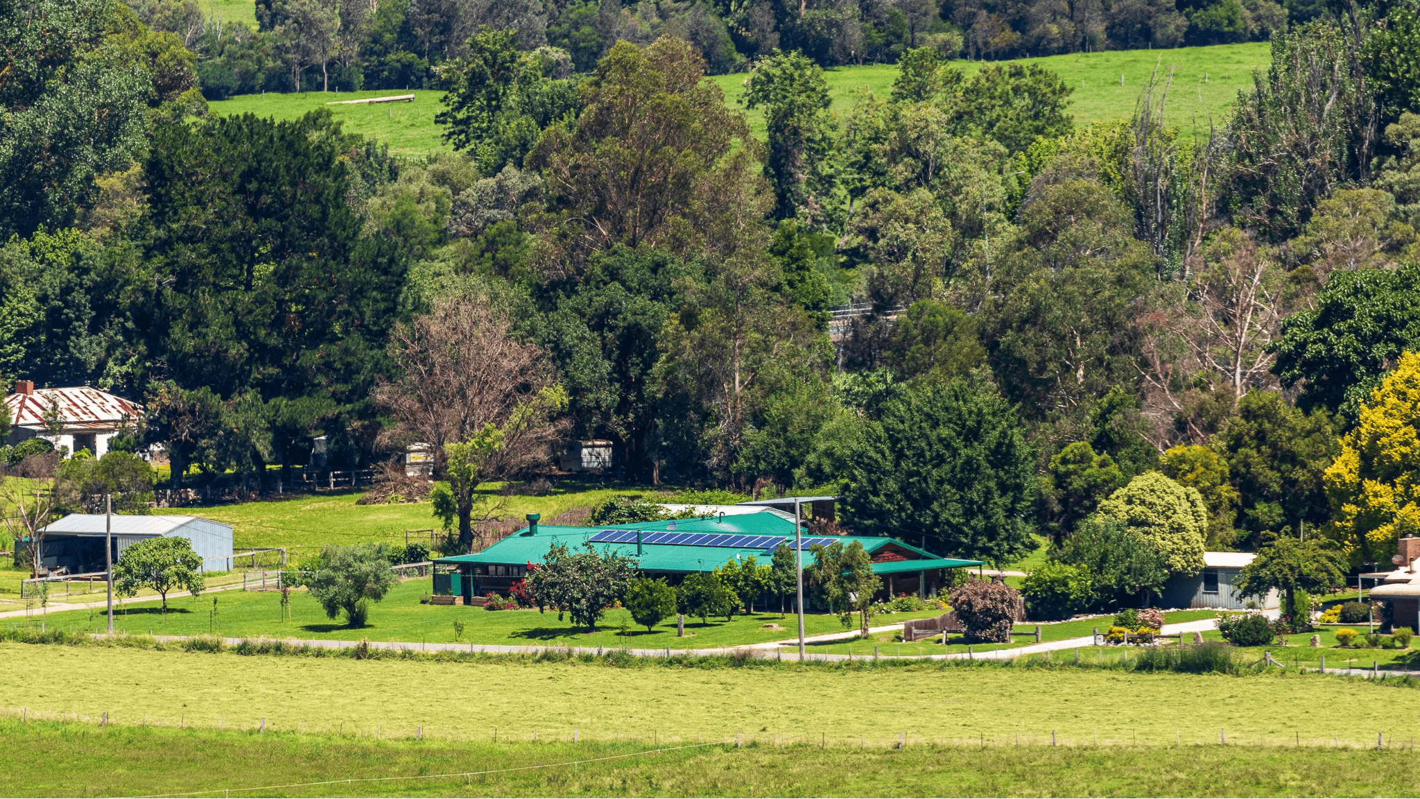 a building Nestled among hills and trees of the bushlands