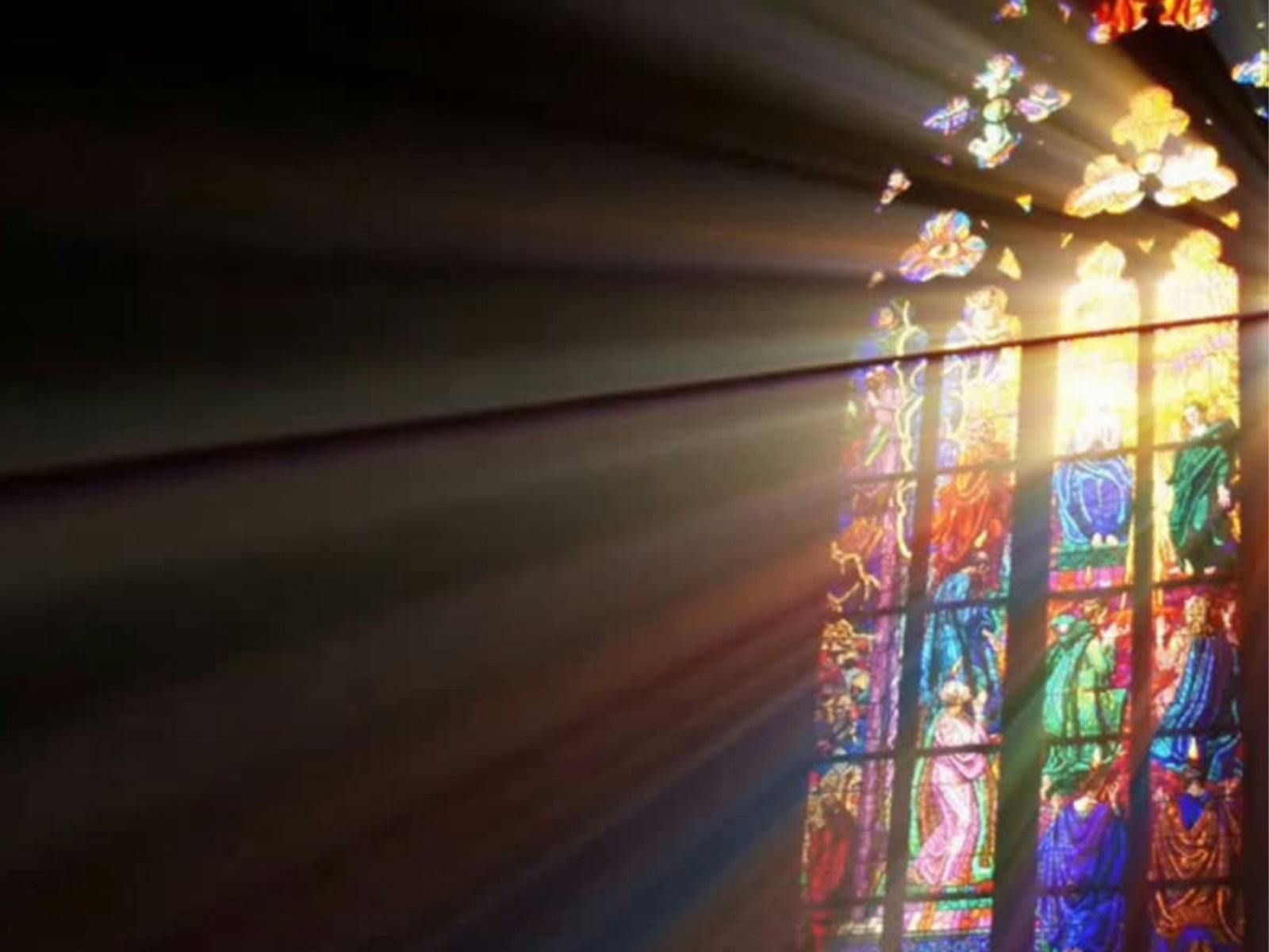 A photo of light streaming through a beautiful stained glass window