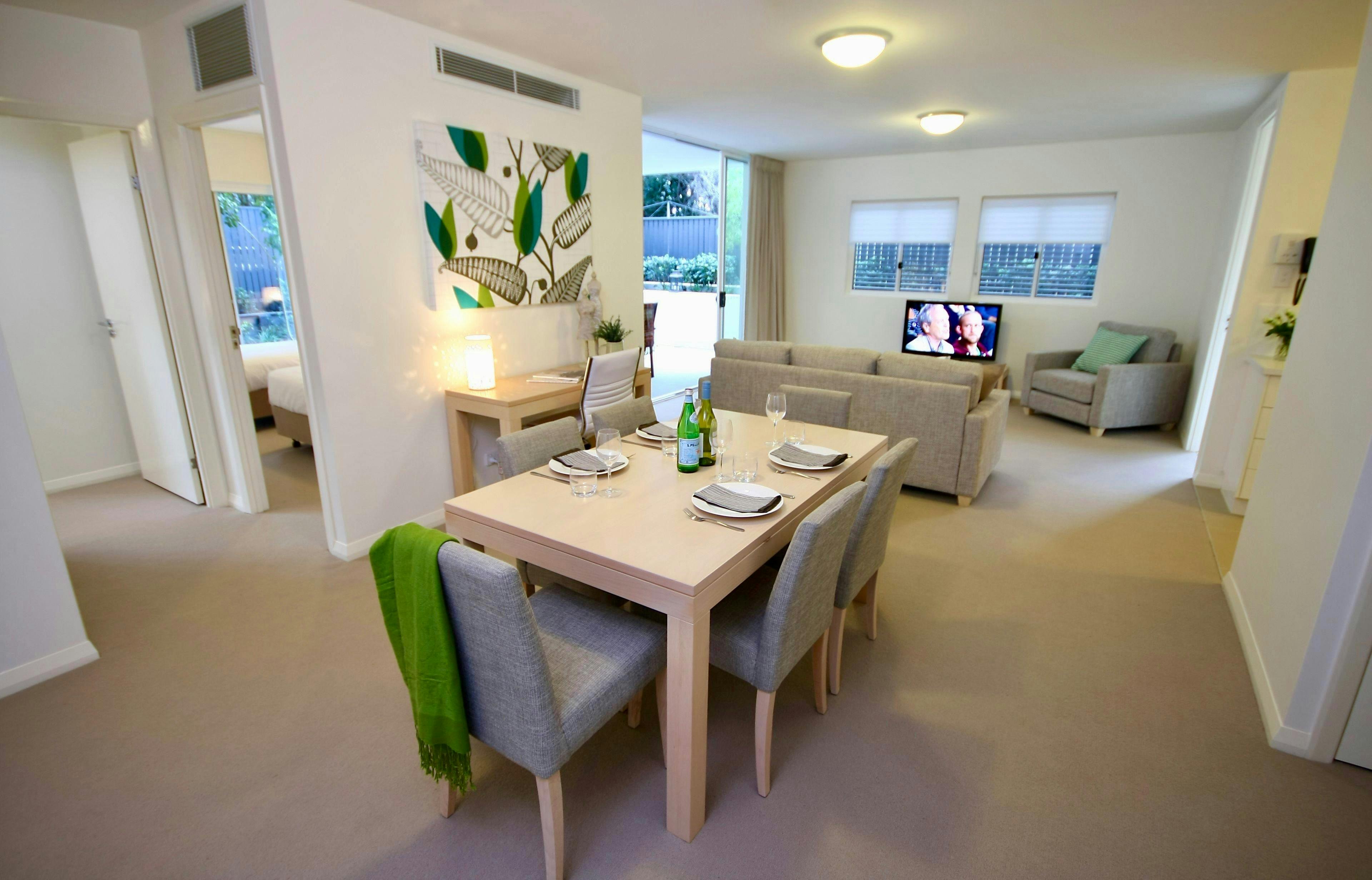 Open-plan living and dining area in a two-bedroom apartment