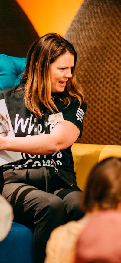Photo of a Museum staff member and an Auslan interpreter signing a book in the Discovery Centre