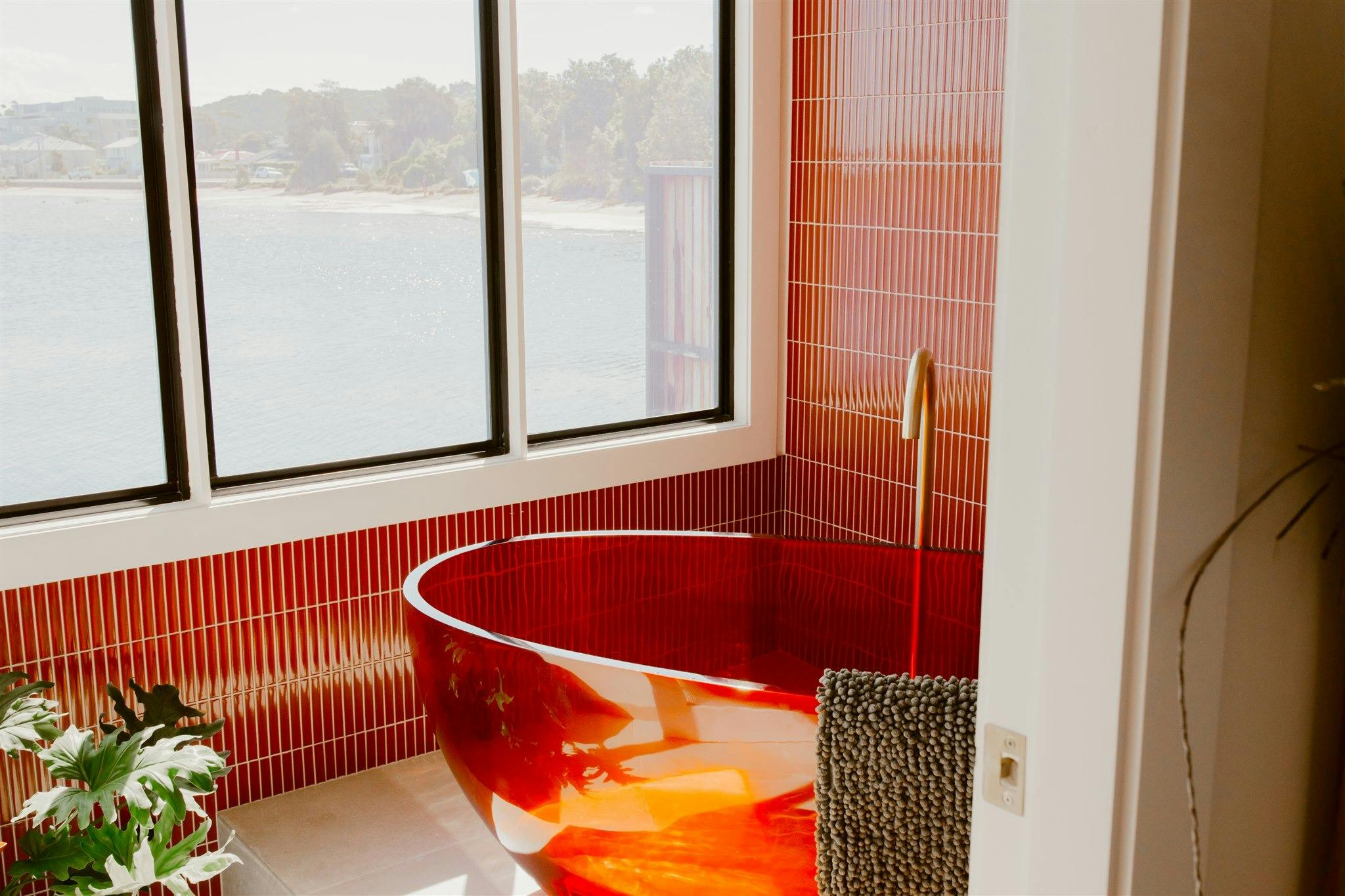 Red Bathtub and window overlooking the lake