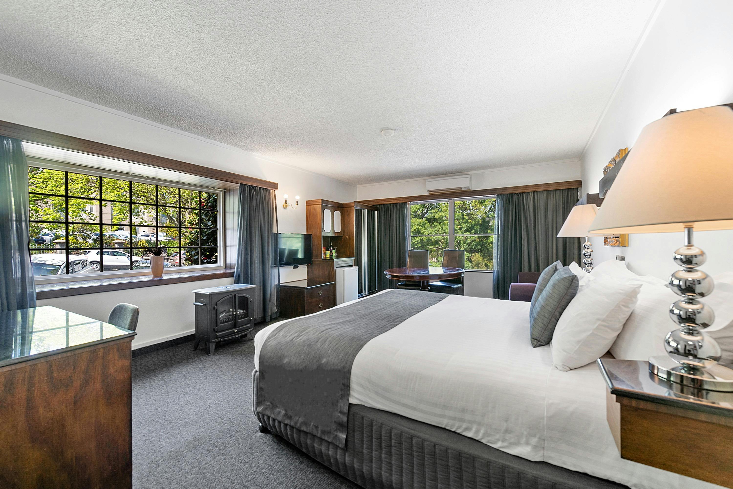 Luxurious king bed with black marble tiled bathroom