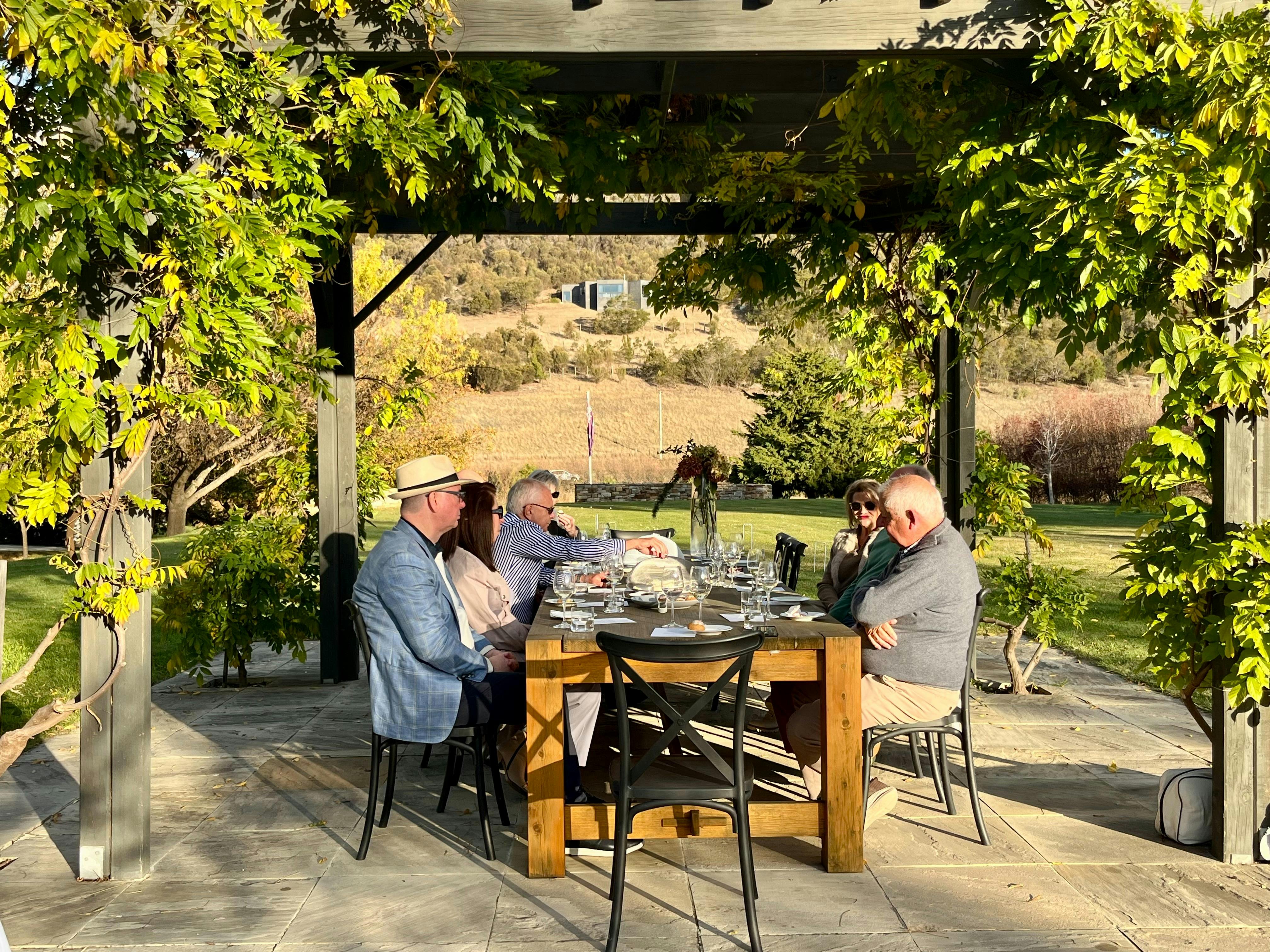 A group of happpy guests dining at a large ta