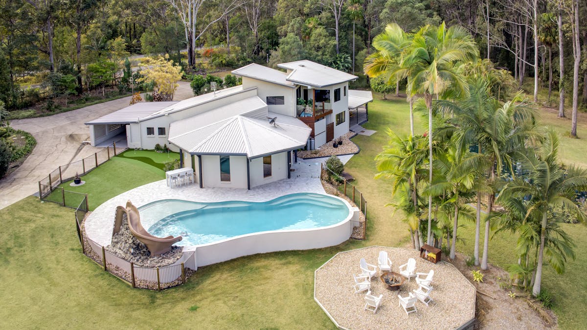 Pool overlooking the stunning rainforest with a slide and fire pit.