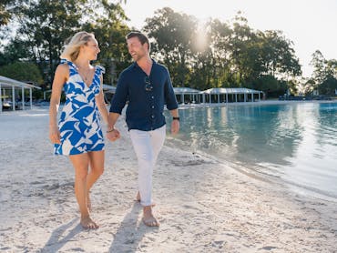 Couple walking on the lagoon beach