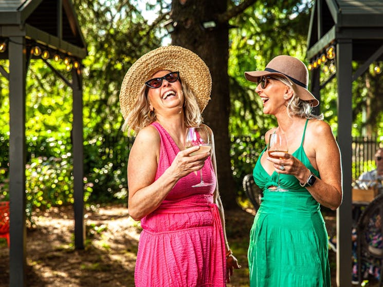 Two women laughing with drinks