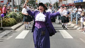 The town cryer leads the parade