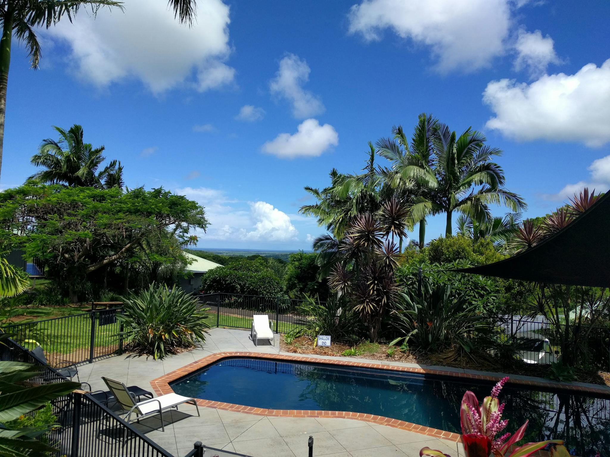 Image of a pool set on the grounds of the accommodation with hills in the background