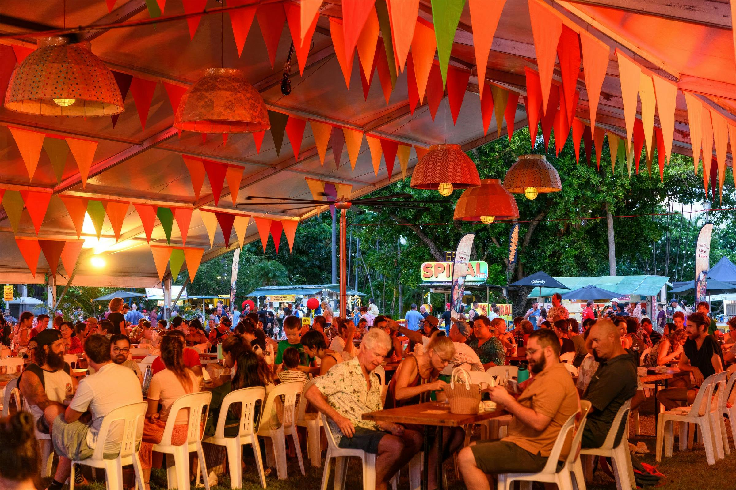 Crowds dining under a colourful decorated marquee at the Darwin International Laksa Festival.